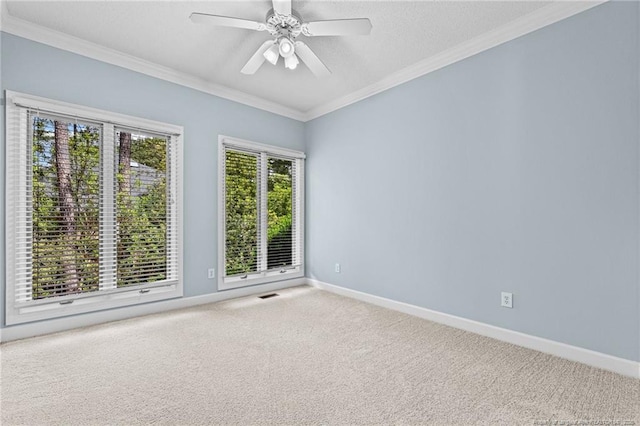 unfurnished room with ceiling fan, crown molding, and carpet floors