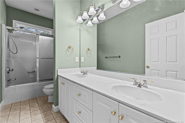 full bathroom with toilet, bath / shower combo with glass door, tile patterned flooring, and vanity