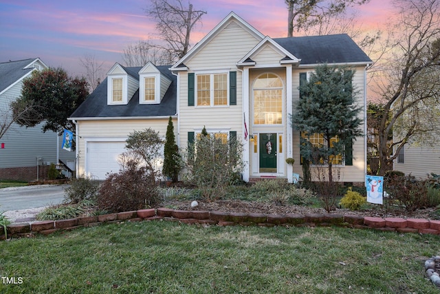 view of front of home featuring a yard and a garage