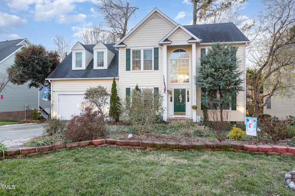 view of front facade with a front yard and a garage