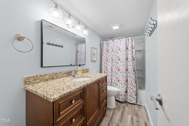 full bathroom featuring shower / bathtub combination with curtain, vanity, toilet, and hardwood / wood-style floors