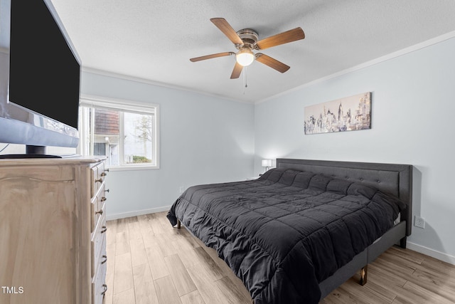 bedroom with crown molding, light hardwood / wood-style floors, ceiling fan, and a textured ceiling