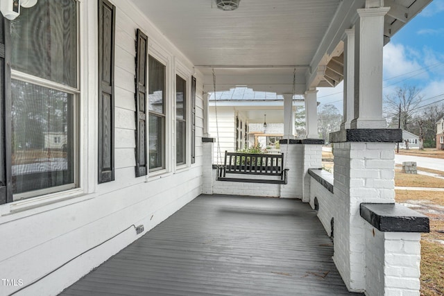 wooden terrace featuring a porch