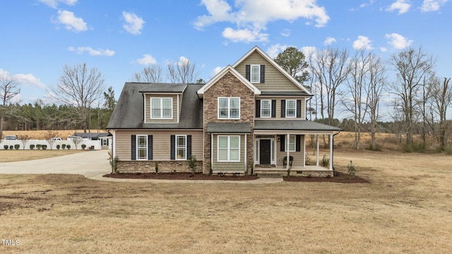 craftsman house with covered porch and a front lawn