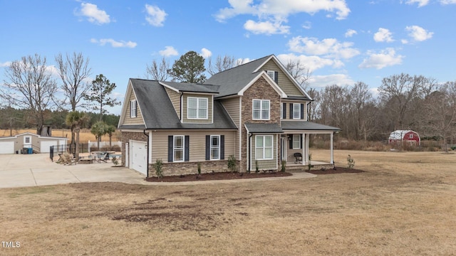 view of front facade with covered porch, a front lawn, and a garage