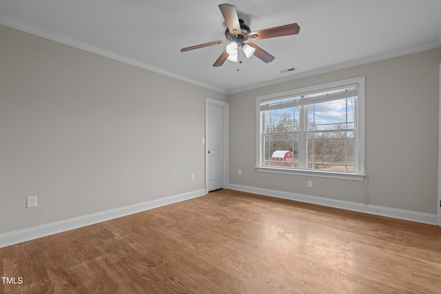 spare room with ornamental molding and ceiling fan