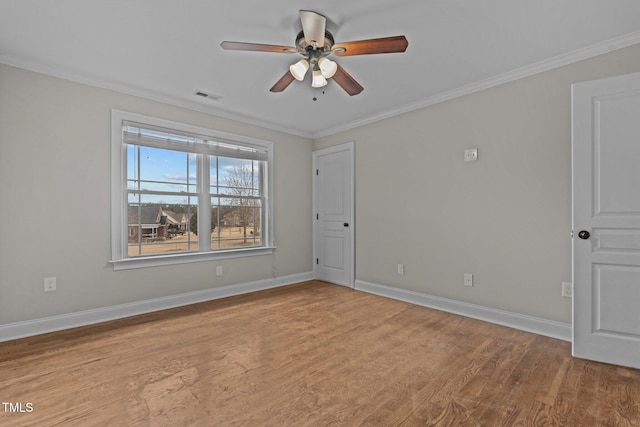 unfurnished room featuring ceiling fan, light wood-type flooring, and crown molding