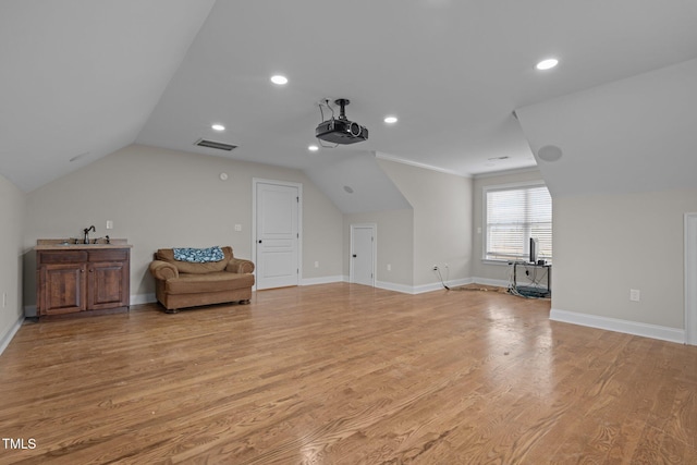 bonus room with sink, lofted ceiling, and light wood-type flooring