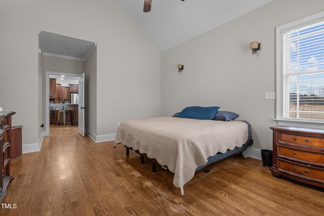 bedroom featuring lofted ceiling, ornamental molding, ceiling fan, and hardwood / wood-style floors