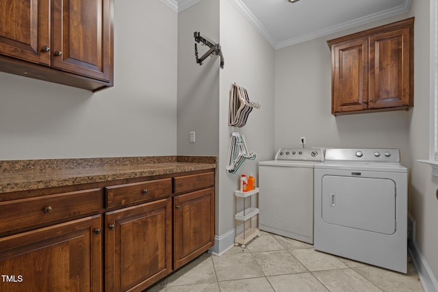 clothes washing area featuring independent washer and dryer, light tile patterned floors, cabinets, and crown molding