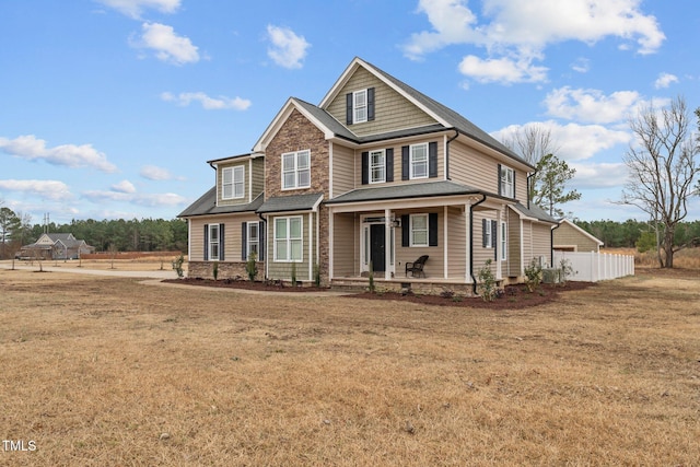 craftsman-style house featuring a porch and a front lawn