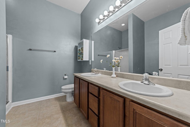 bathroom featuring a shower with door, toilet, and vanity