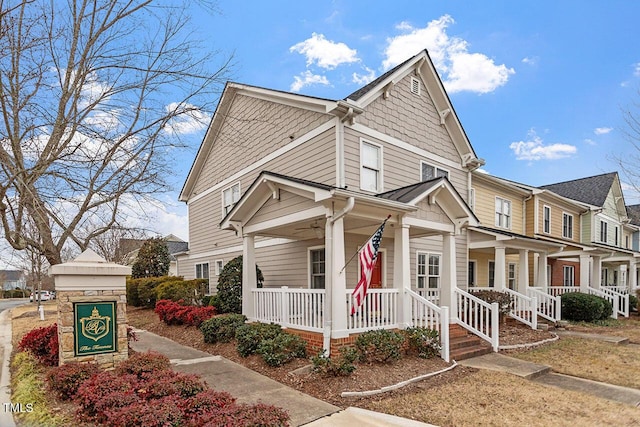 townhome / multi-family property featuring covered porch