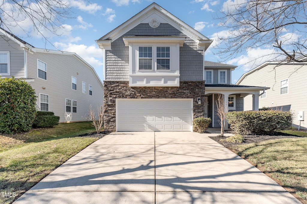 view of front of home featuring a front yard and a garage