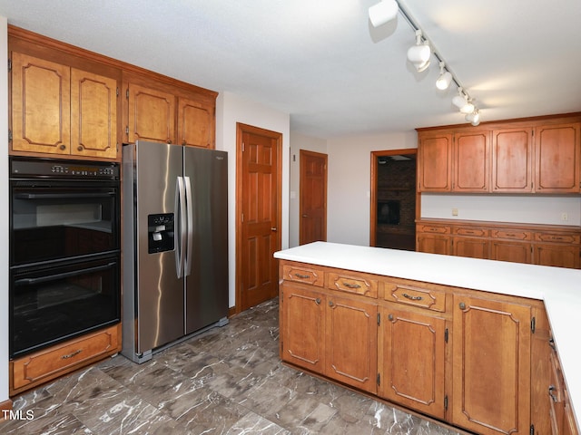 kitchen with stainless steel fridge and double oven