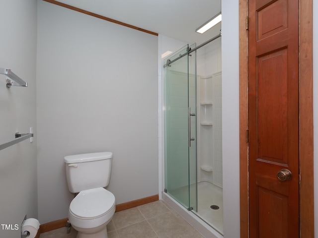 bathroom with tile patterned flooring, a shower with door, and toilet