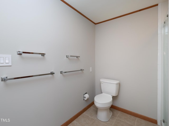 bathroom with crown molding, tile patterned floors, and toilet