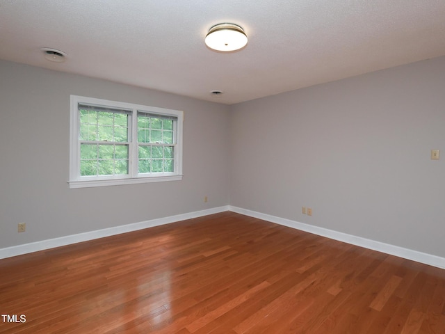 empty room with wood-type flooring