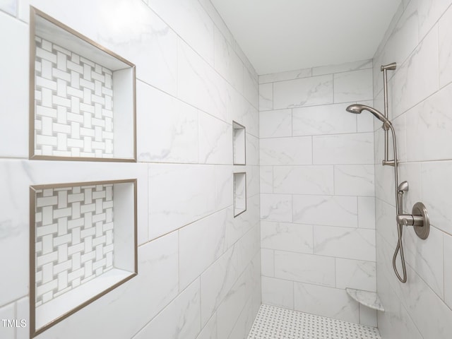 bathroom with a tile shower