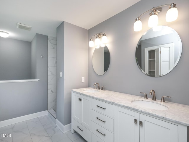 bathroom featuring vanity and tiled shower