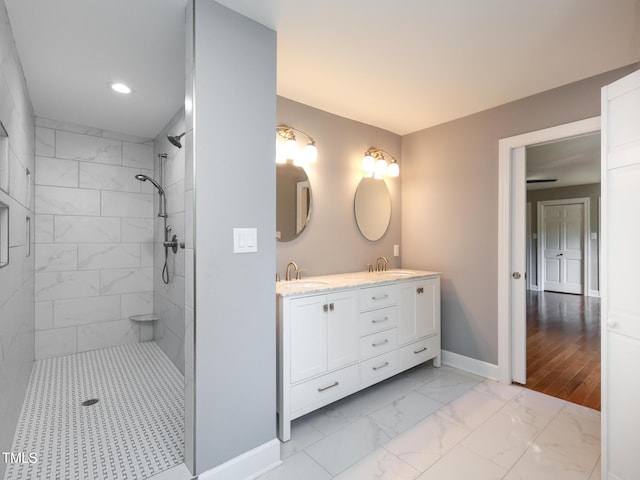 bathroom with vanity and a tile shower