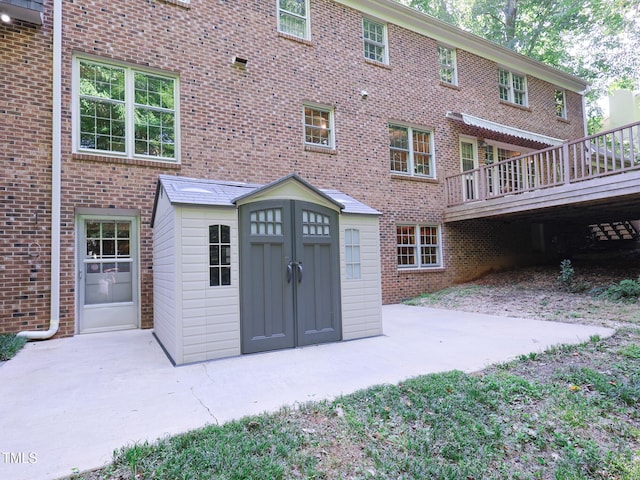 back of property featuring a wooden deck and a patio area