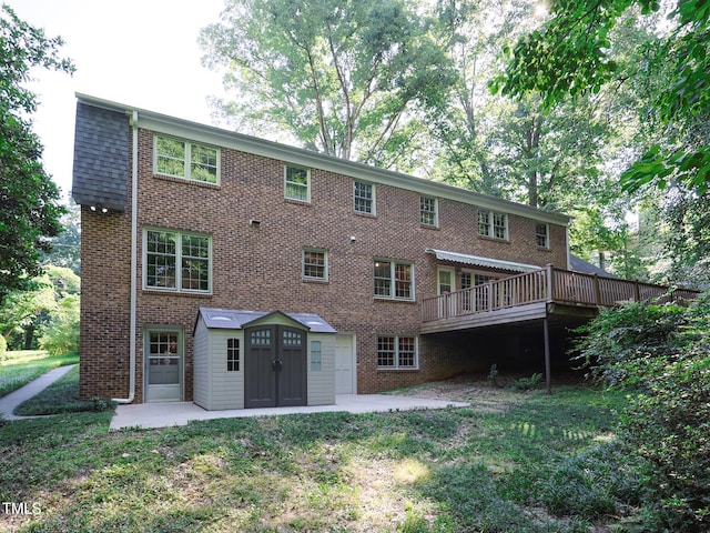 back of property featuring a lawn, a patio, and a deck