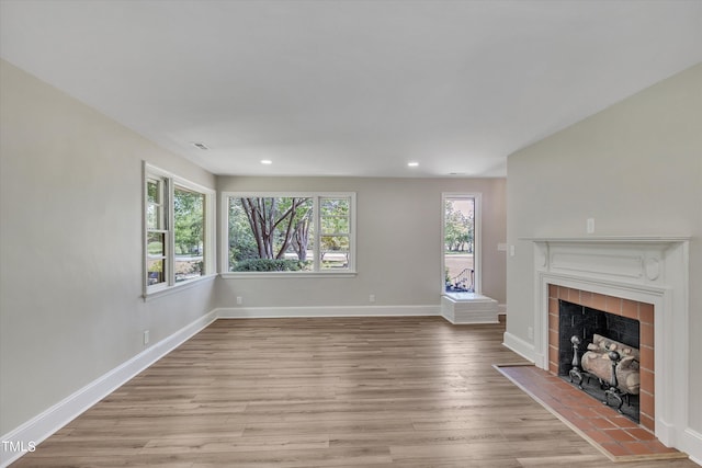 unfurnished living room with light hardwood / wood-style floors and a fireplace