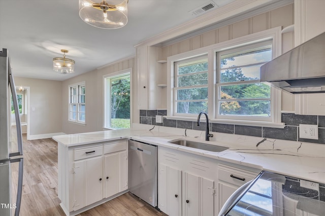 kitchen with light stone countertops, sink, white cabinetry, and appliances with stainless steel finishes