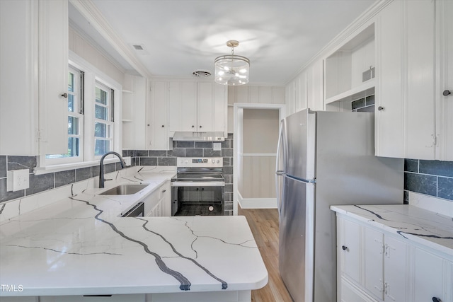 kitchen with decorative light fixtures, white cabinets, appliances with stainless steel finishes, and crown molding