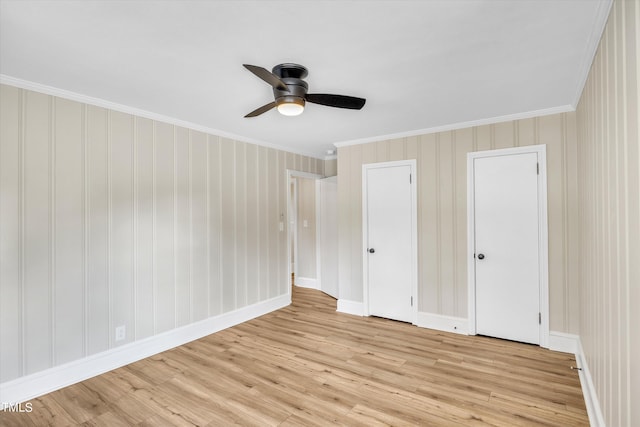 unfurnished bedroom with ceiling fan, ornamental molding, and light hardwood / wood-style flooring