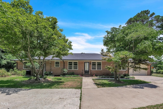 ranch-style home with a front yard and a garage