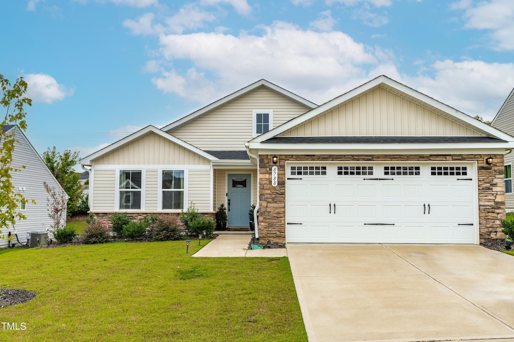 craftsman-style home featuring a front yard, central AC, and a garage