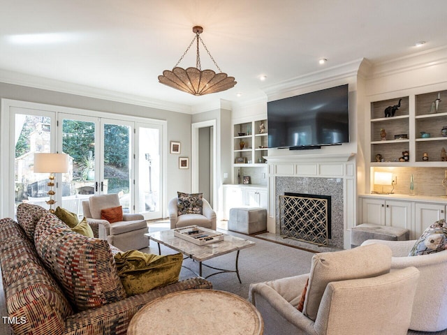 living room featuring a premium fireplace, ornamental molding, and built in features