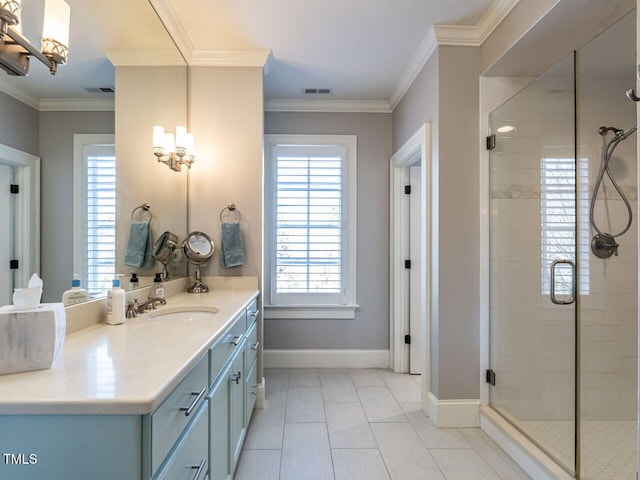 bathroom with ornamental molding, tile patterned flooring, a shower with door, and vanity