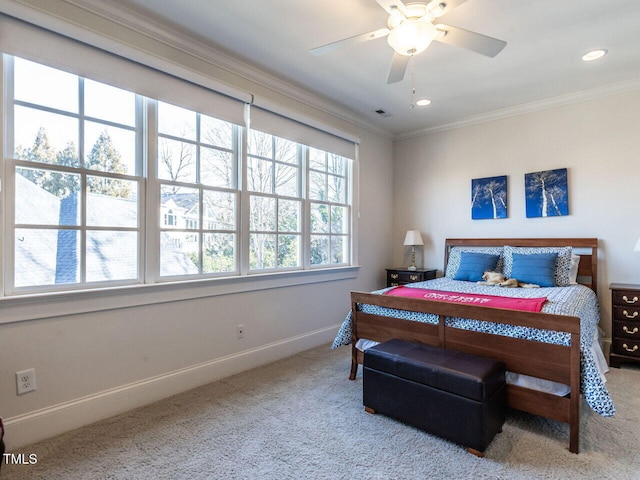 carpeted bedroom with crown molding and ceiling fan