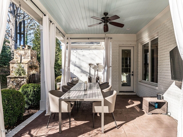 view of patio / terrace featuring a fireplace and ceiling fan