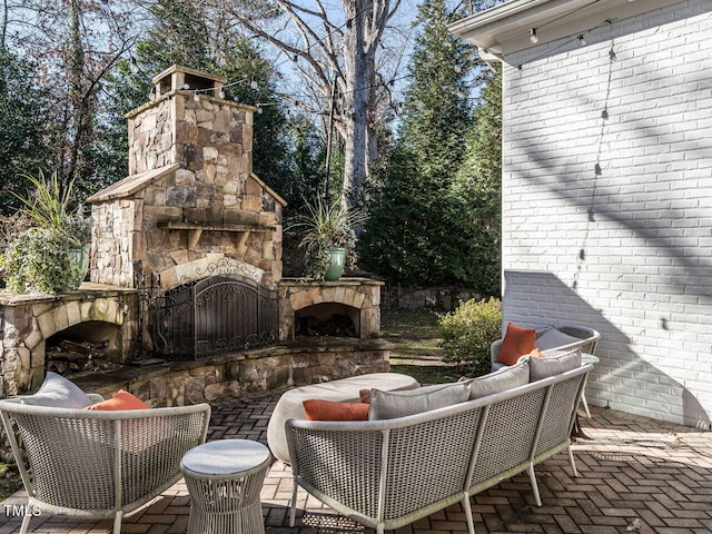 view of patio featuring an outdoor living space with a fireplace