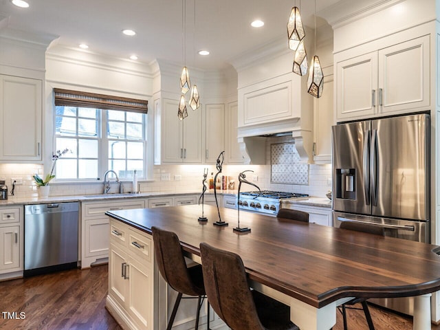 2900 Glenanneve Pl, Raleigh, NC 27608 - kitchen featuring appliances with stainless steel finishes, a sink, crown molding, backsplash, and wood counters