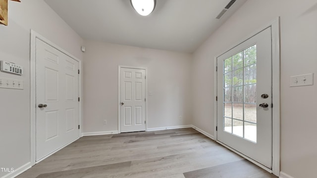 doorway to outside with light hardwood / wood-style flooring and a wealth of natural light