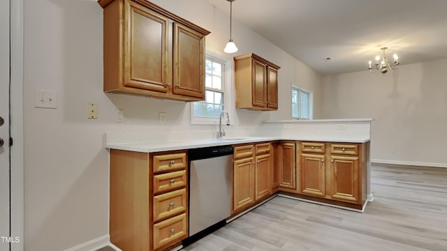 kitchen with sink, dishwasher, light hardwood / wood-style floors, a chandelier, and pendant lighting