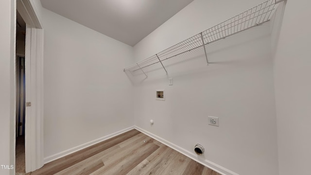 clothes washing area with washer hookup, light hardwood / wood-style flooring, and hookup for an electric dryer