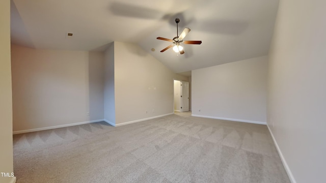 carpeted empty room featuring ceiling fan and vaulted ceiling