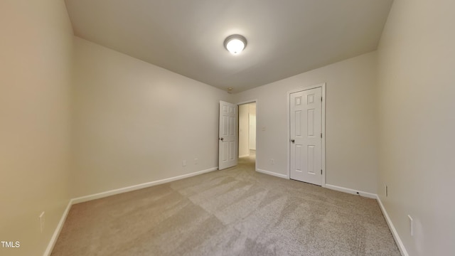 unfurnished bedroom with a closet and light carpet