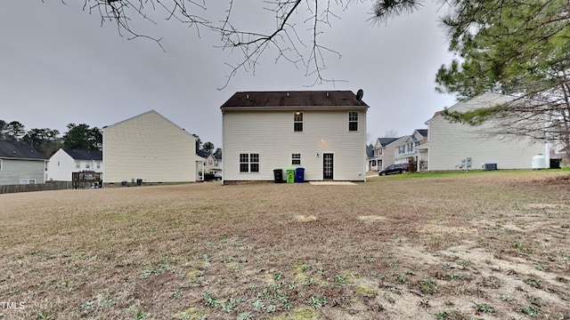 back of house with central AC unit