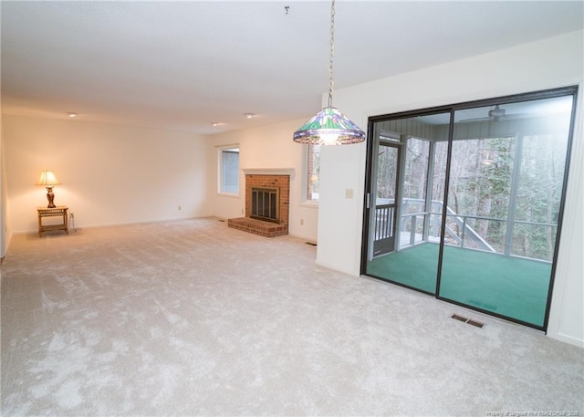 unfurnished living room featuring carpet flooring and a fireplace