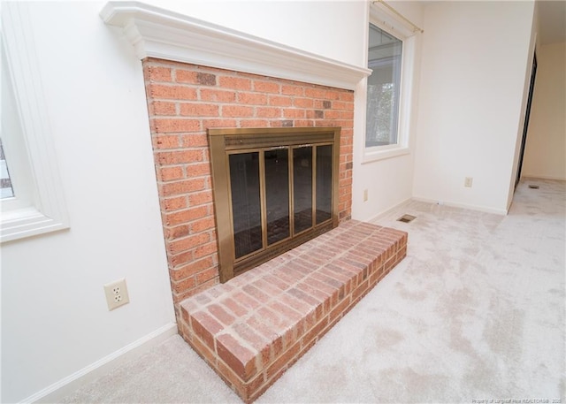 details with a brick fireplace and carpet