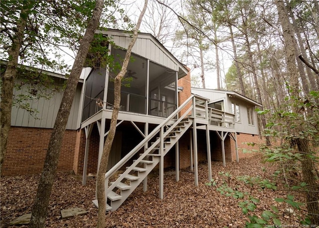 rear view of property with a deck and a sunroom