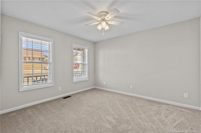 carpeted empty room featuring ceiling fan