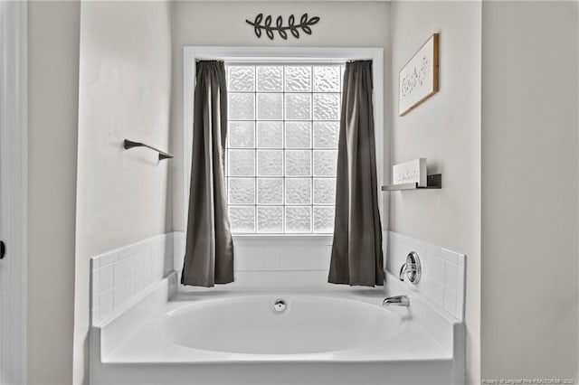 bathroom with a bath and a wealth of natural light